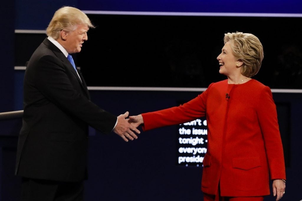 Republican presidential nominee Donald Trump and Democratic presidential nominee Hillary Clinton shake hands during the presidential debate at Hofstra University in Hempstead, N.Y.Donald Trump has often used election funds to pay his own company for private jet charters. 