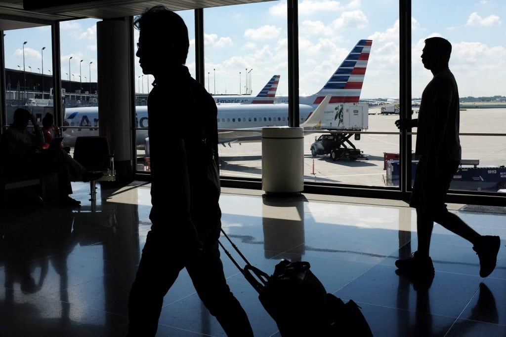 The outlook for increased travel is still strong for the U.S., according to U.S. Travel. Passengers walk to their gates through the terminal as American Airlines planes wait to depart at O'Hare International Airport in Chicago.