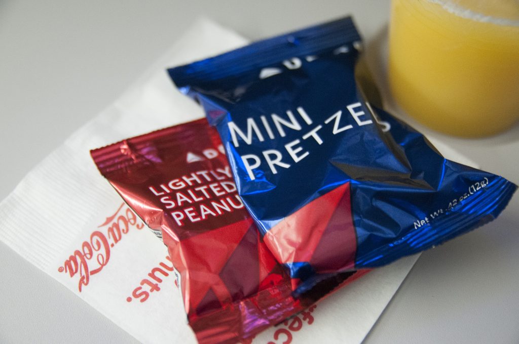 Delta gives free pretzels and peanuts to passengers. Now it is testing whether it should go further and provide substantial snacks on long flights. 
