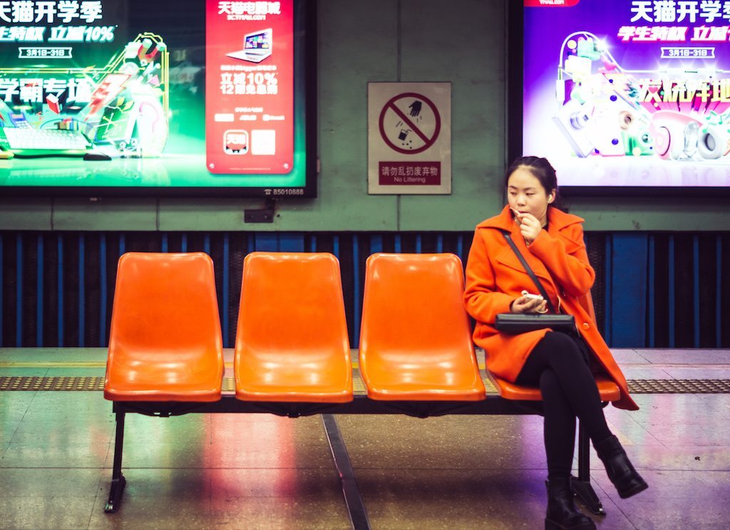Corporate travel competition is heating up in China, which is now the biggest business travel market in the world. Here, a Chinese businesswoman sits at a train station in Beijing.