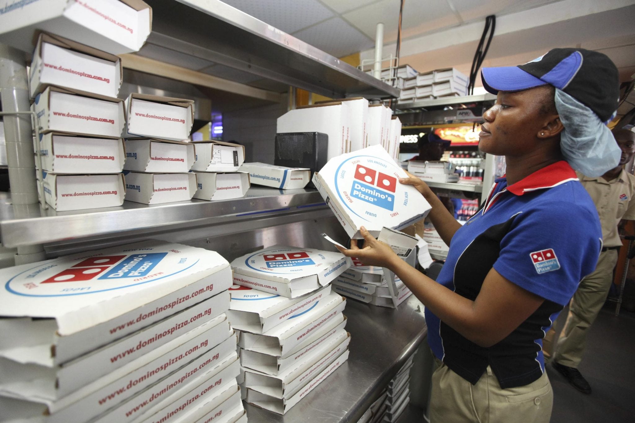 A worker prepares boxes at a Domino's pizza restaurant in Lagos, Nigeria. The company's CEO is obsessed with logistics first. 