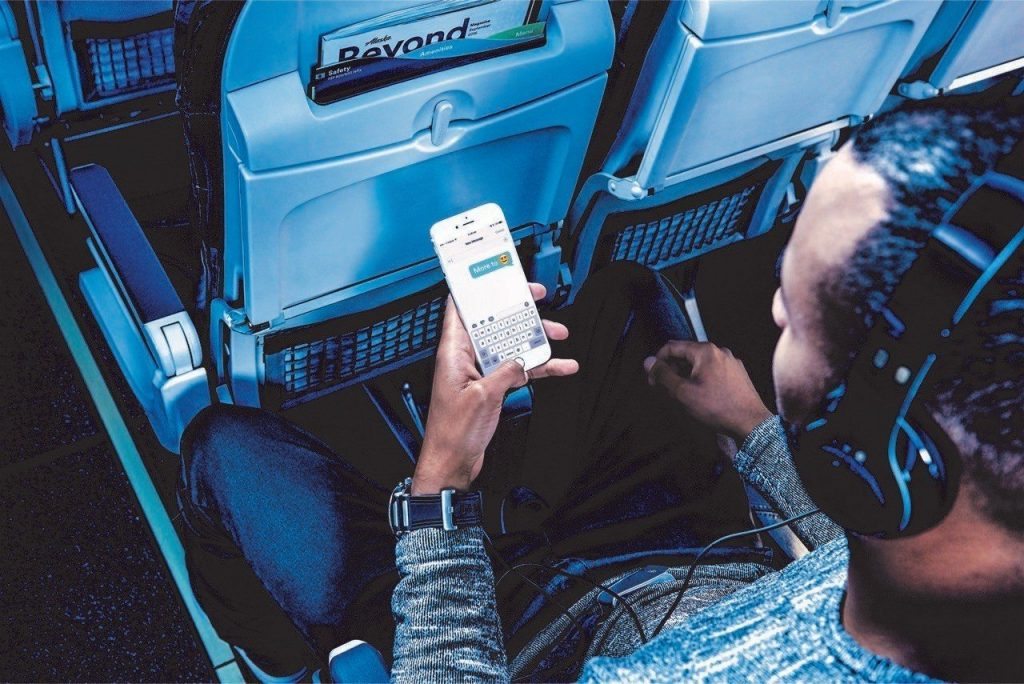 A promotional image from Alaska Air of a passenger texting. The airline is offering free messaging via its Gogo in-flight Internet. 