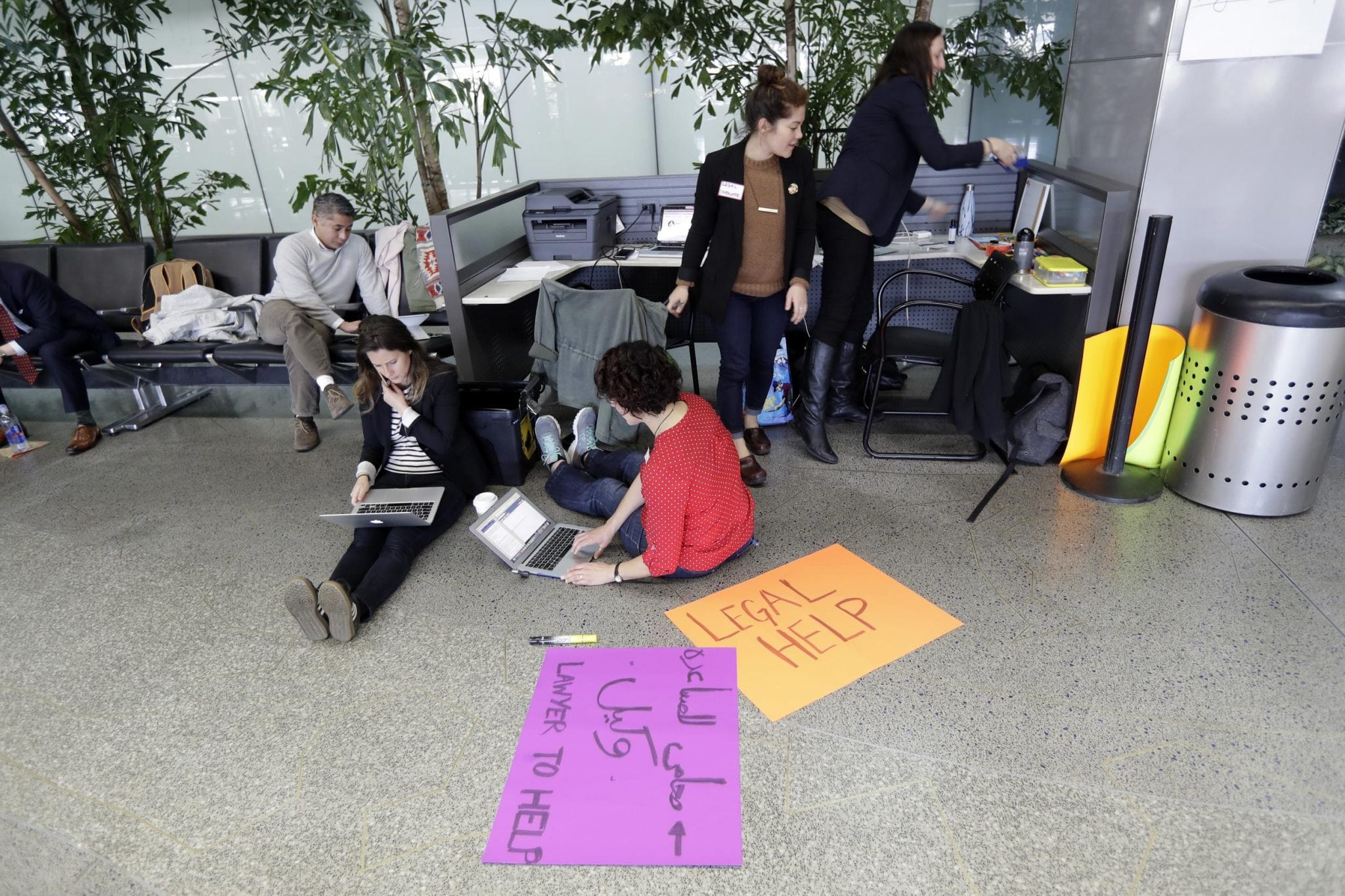 Attorneys offer legal help on Monday at San Francisco International Airport following President Donald Trump's travel ban. Nearly 40 percent of companies responding to a survey said they expect to reduce business travel as a result.