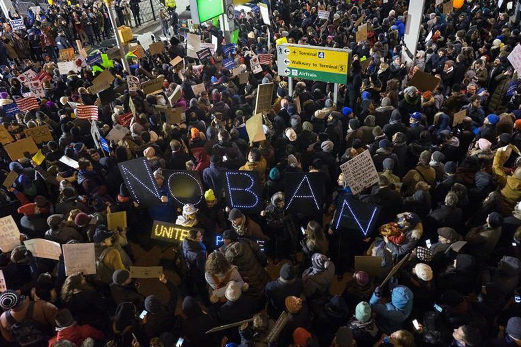Protesters assemble at John F. Kennedy International Airport in New York, Saturday, January 28, 2017. While certain travel companies have been vocal about voicing their concerns over the ban, some companies, particularly hotels, have been reluctant to make public statements.  