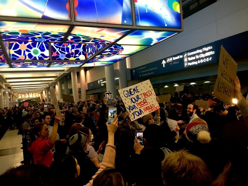 A crowd at Chicago O'Hare International Airport protests President Donald Trump's executive order banning travel from seven Muslim-majority countries. According to a new survey, 31 percent of companies expect the ban to cause them to reduce travel.