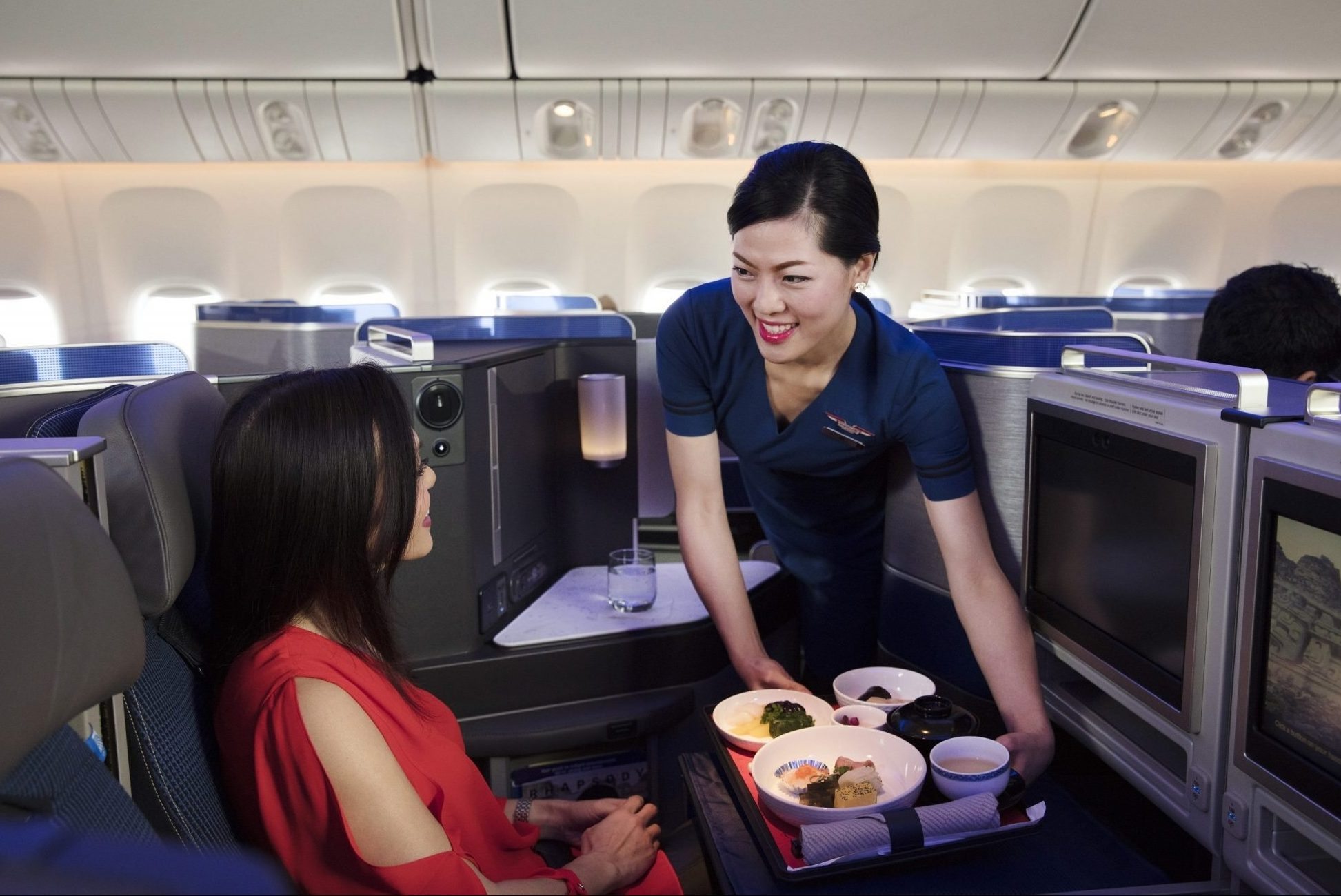 A promotional image of dining service in United's new Polaris seats, which have been delayed. 