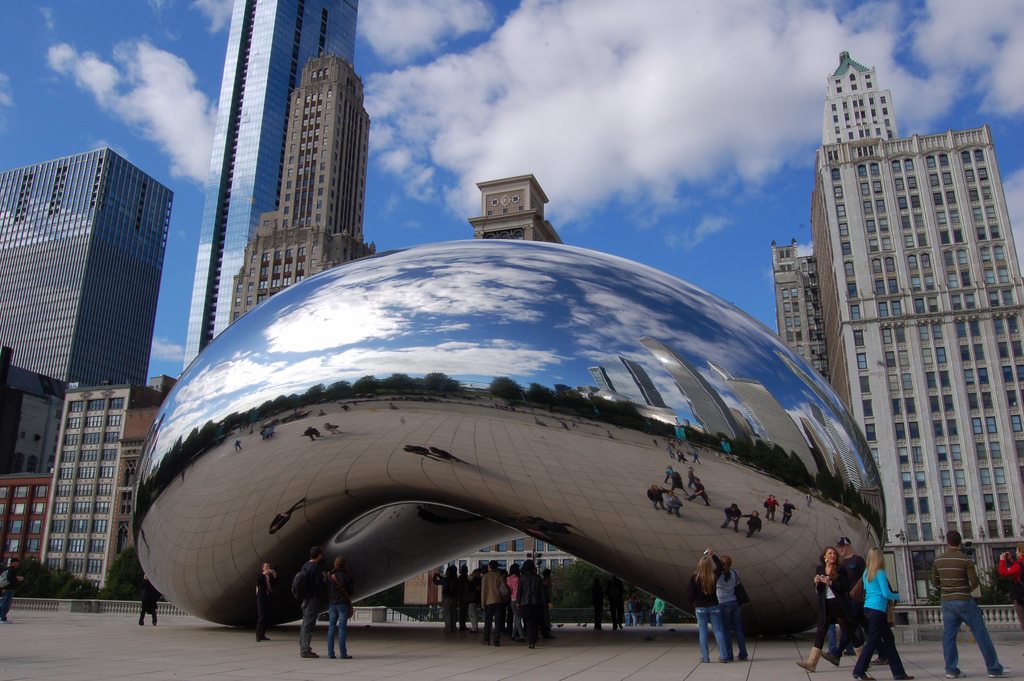 Online international bookings on flights to the U.S. have largely decreased in early 2017. Tourists in Chicago's Millenium Park mill around in this photo.