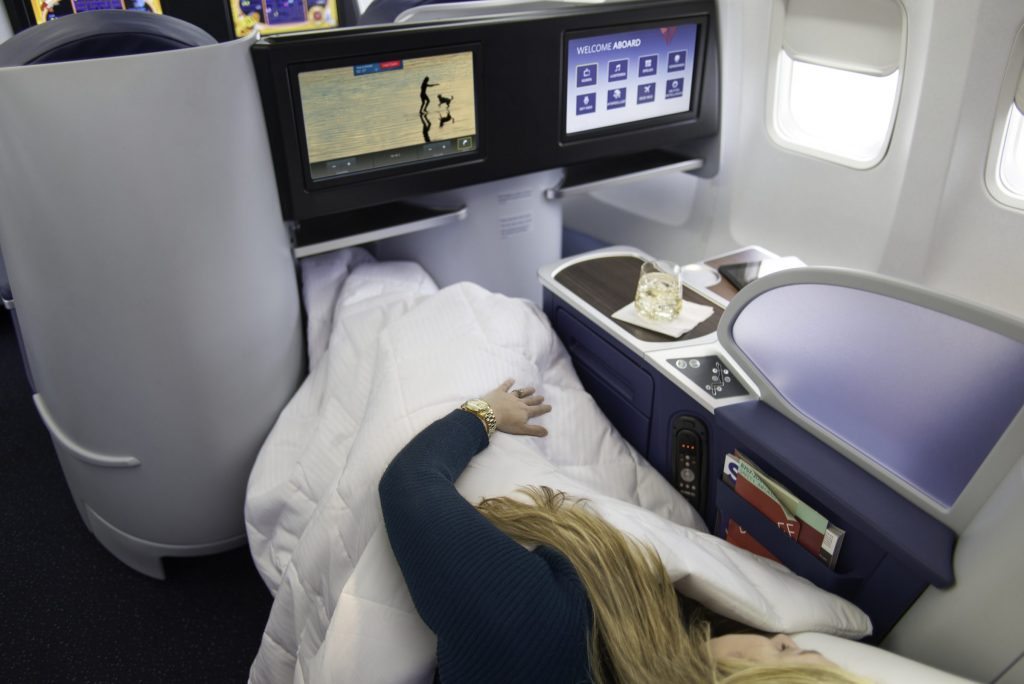 Delta frequent flyers, like this one taking a snooze, are seeing improvement with premium cabins.