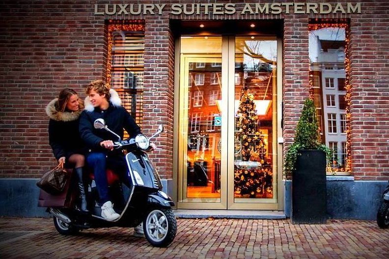 European Union competition authorities have tried to crack down on rate parity clauses in recent years. Pictured are guests who rented a scooter at Luxury Suites Amsterdam.