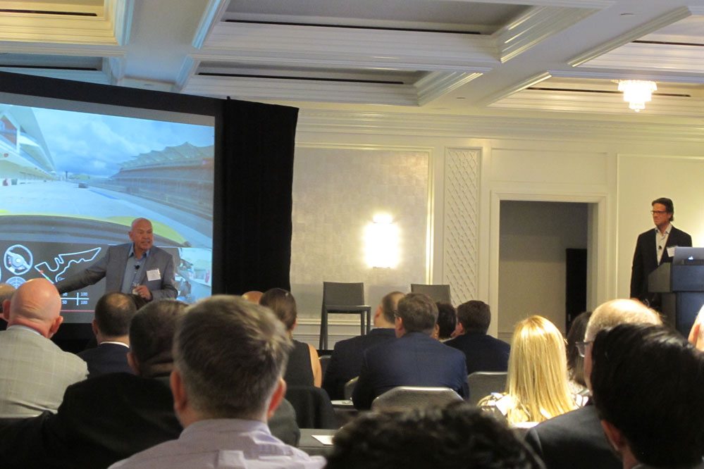 Lee Pillsbury, the firm's newly added managing director, uses a Ferrari racetrack drive he recently took to make a point, while Thayer Ventures founding partner Chris Hemmeter looks on, at the investment firm's annual conference at the Ritz Carlton on Stockton Street in San Francisco.