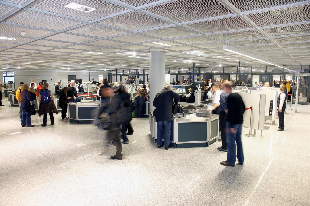 Passengers go through security screening at Frankfurt Airport. Politico reported that the United States may not implement an electronics ban on planes, at least not soon.