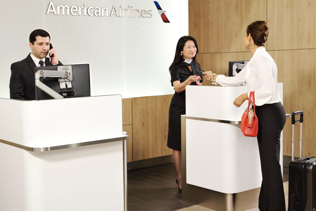 A promotional image of a customer at American Airlines' renovated  Admiral's Lounge. The carrier will now factor in the amount of money a loyalty member spends when awarding upgrades. 