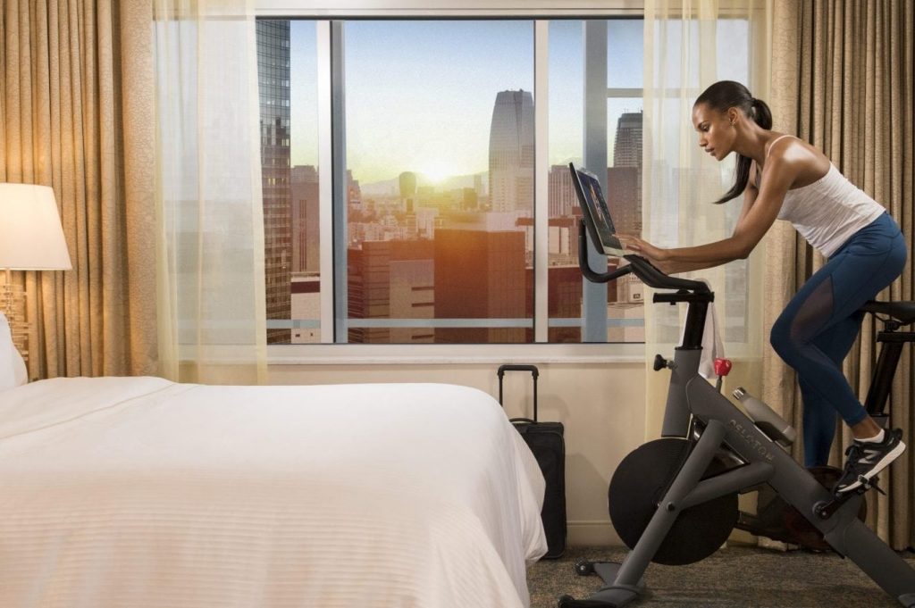 Expedia is the subject of a lawsuit alleging it defrauds consumers in the way it charges consumers certain fees on an affiliate, Reservations.com. Pictured, guest rooms at Westin hotels feature Peloton bikes. 