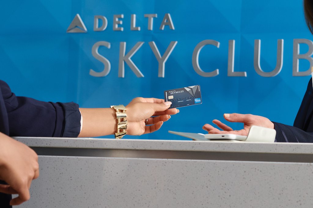 A Delta Air Lines customer hands over an American Express credit card during happier times.