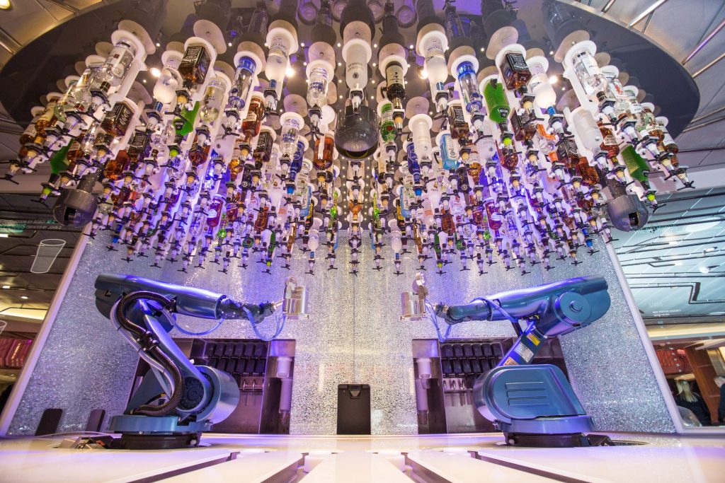 Royal Caribbean says passengers are spending more on drink packages as part of a cruise. Pictured here is the Bionic Bar aboard Quantum of the Seas, a popular gathering place featuring robotic bartenders.