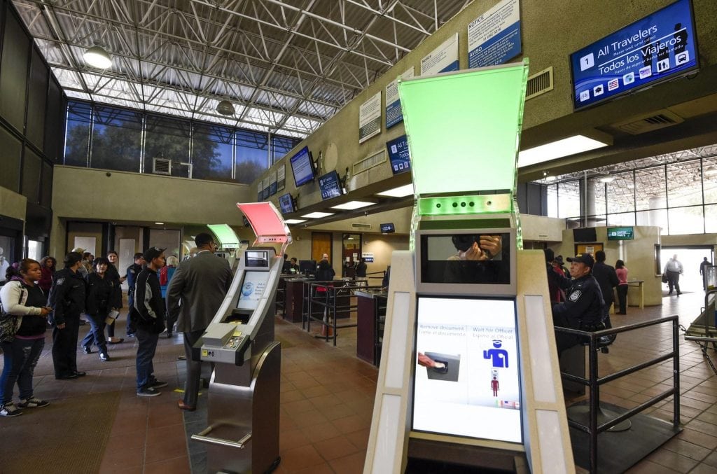 The U.S. Travel and Tourism Office said on Tuesday that a problem at some U.S. Customs and Border Protection kiosks led to errors in international arrivals data. Pictured are pedestrians crossing from Mexico into the United States at the Otay Mesa Port of Entry wait to use biometric kiosks in San Diego. 
