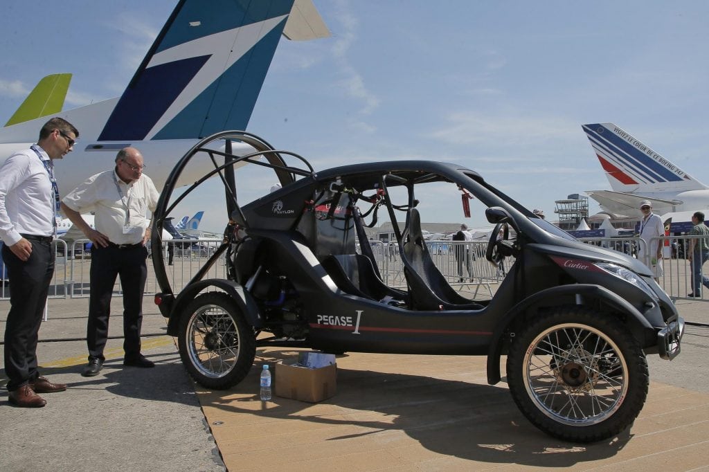 Flying cars are a hot topic for the media, but potentially years away from becoming a mainstream transportation option. Visitors look at the flying car Pegasus 1, built by French entrepreneur Jerome Dauffy, at Paris Air Show.