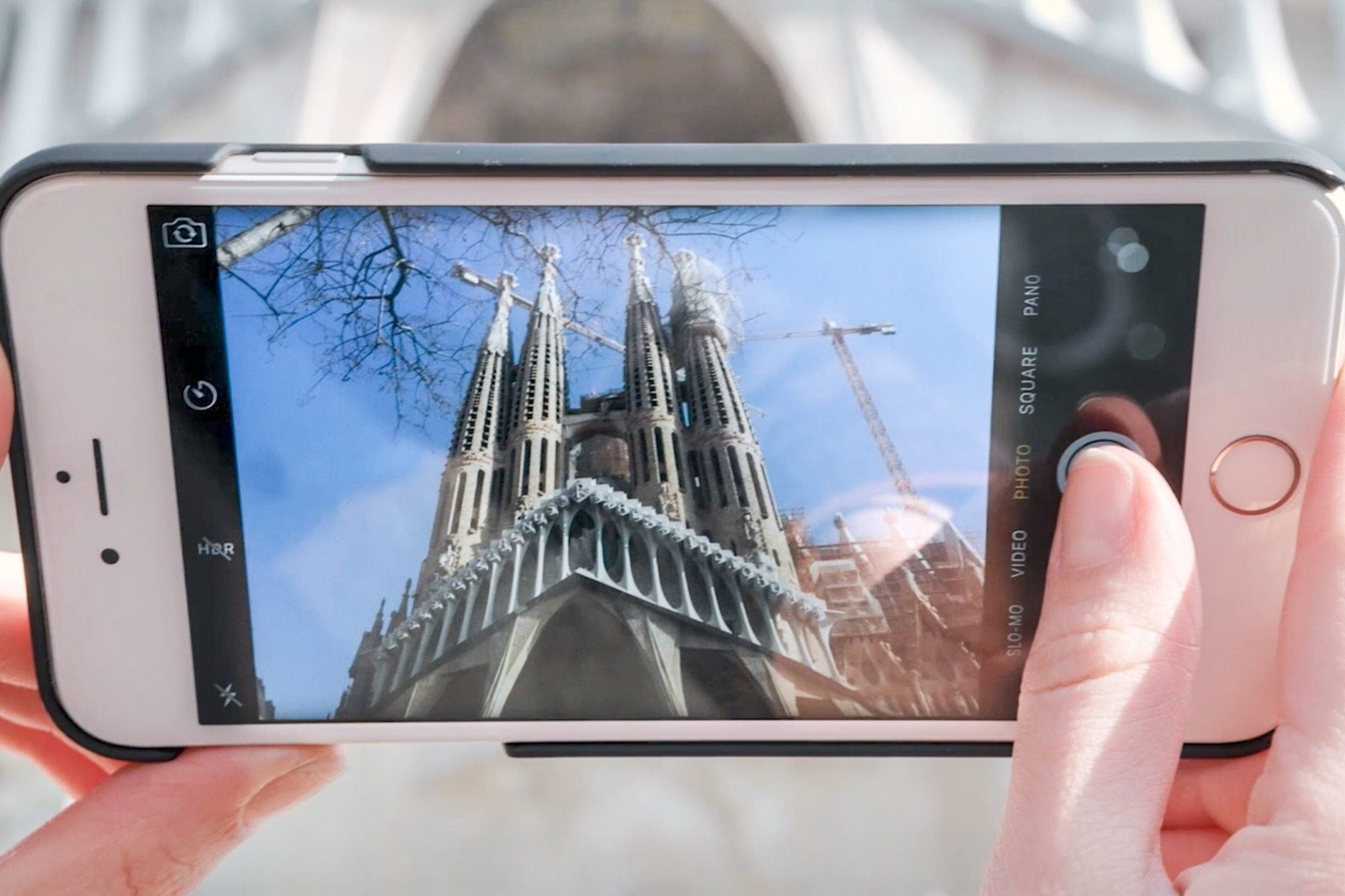 Tourist takes a photo at La Sagrada Familia in Barcelona, Spain. 