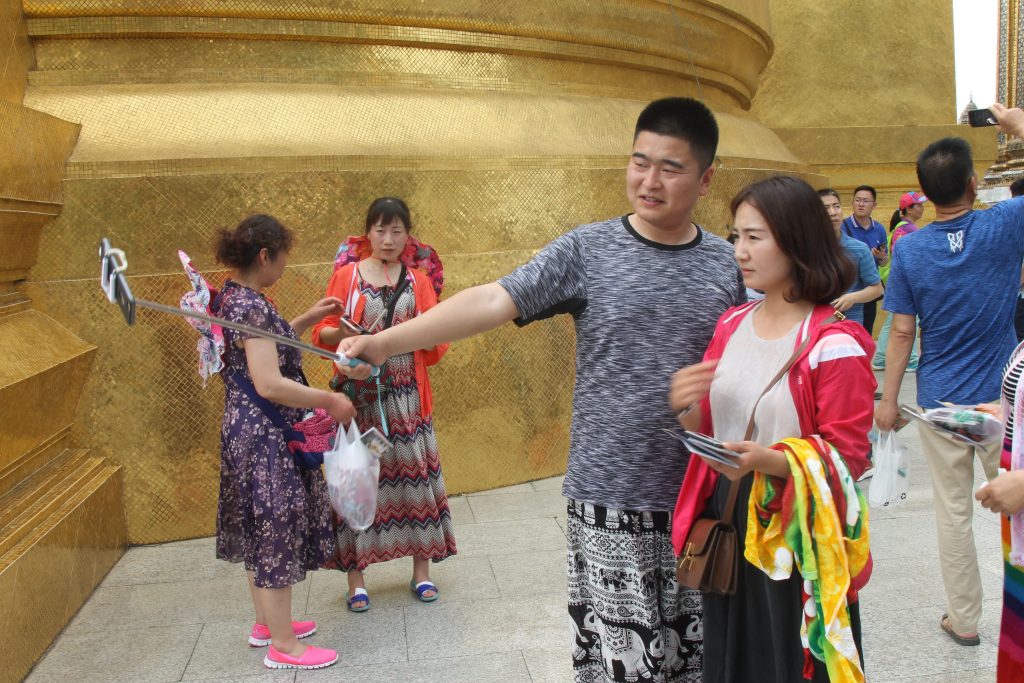 Tourists at the Grand Palace in Bangkok, Thailand.