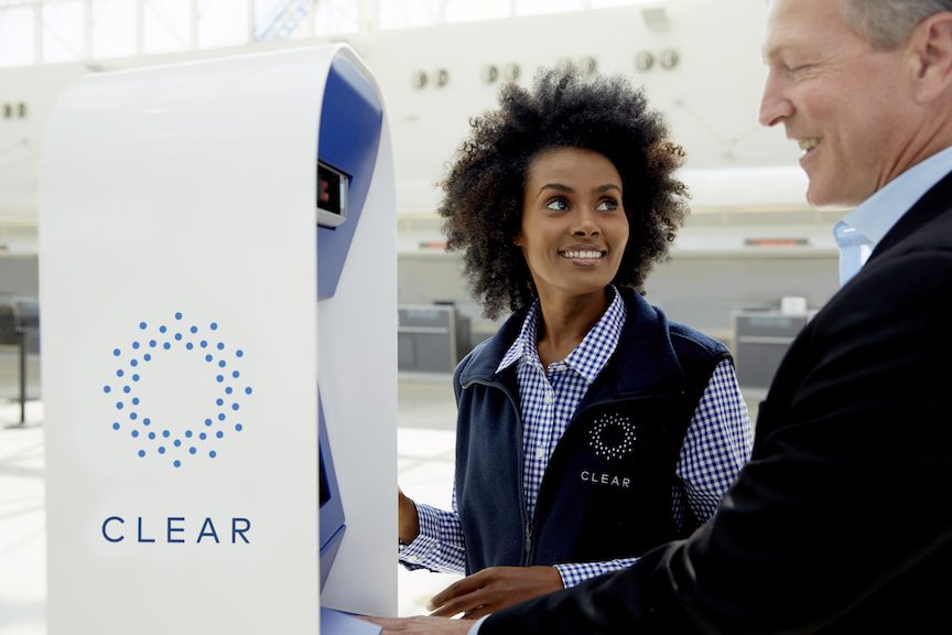 Clear, the biometric security company, has evolved significantly over the last several years. This promotional photo shows a clear station with an employee and a user.