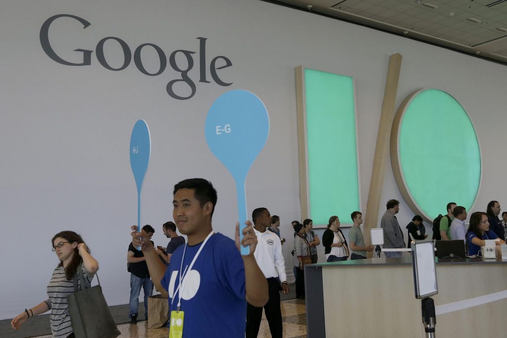 A Google employee helps direct people as they register for Google I/O 2014 in San Francisco, Tuesday, June 24, 2014. 