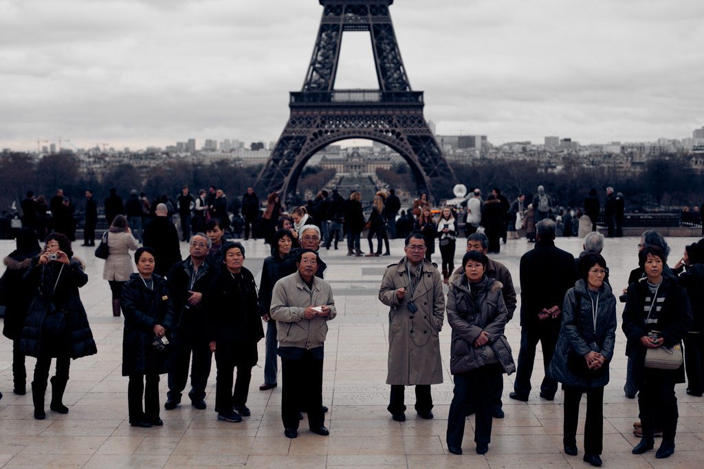 Destinations are increasingly using WeChat to market to Chinese travelers. Pictured are Chinese tourists at the Eiffel Tower in Paris.