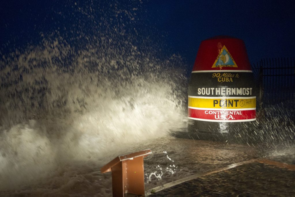 Waves crash against the Southernmost Point in Key West, Florida, as the storm swirls towards the Florida coast. 

