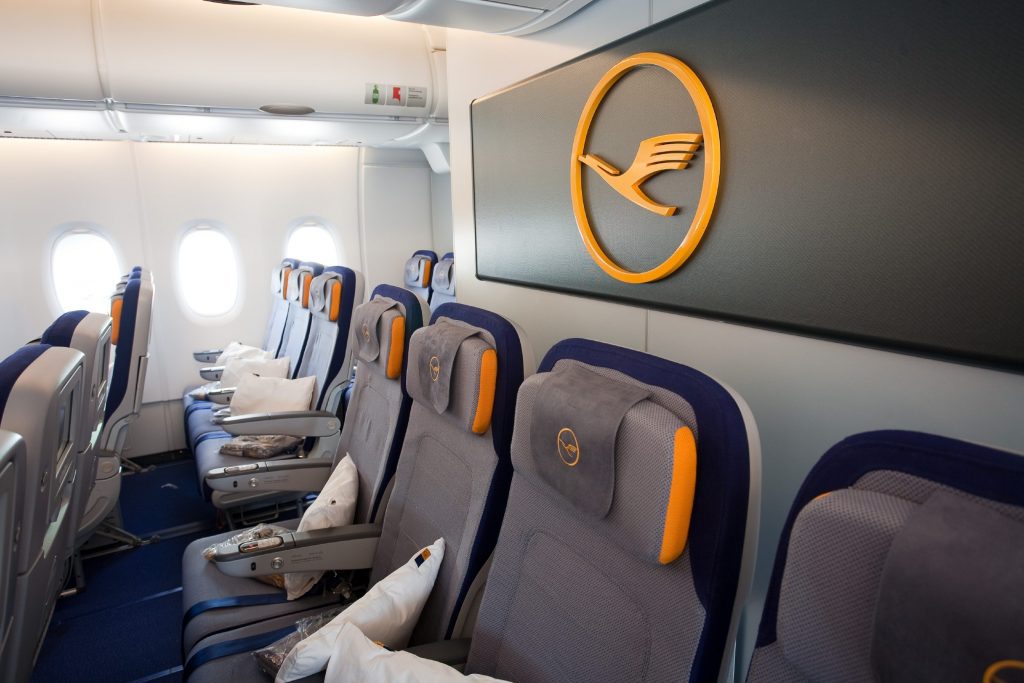 An empty business class section of a Lufthansa jet. 