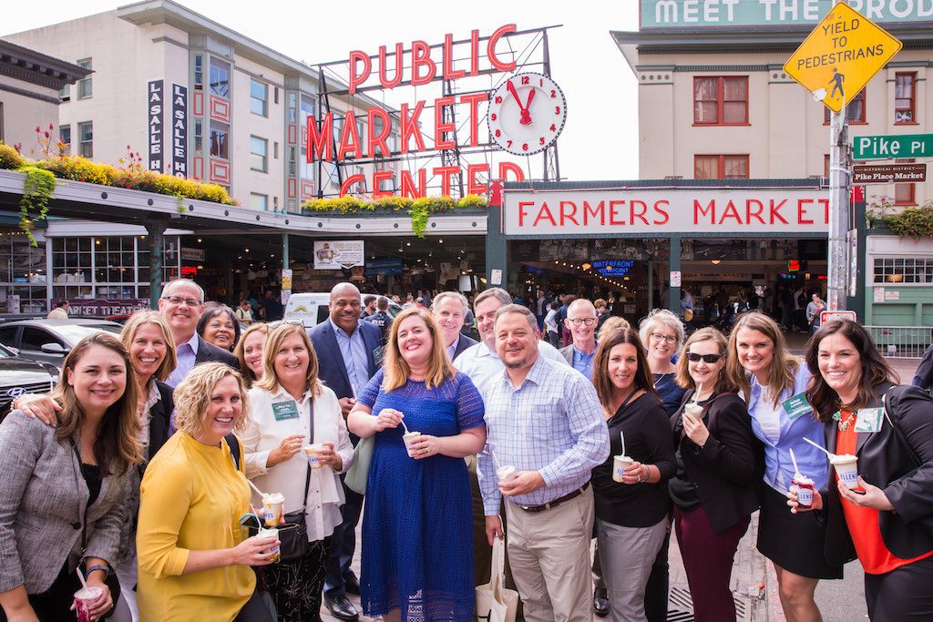 Executives from Visit Seattle and various national associations gather at Seattle's iconic Pike Place Market.