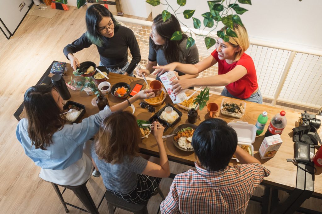 Members of the Klook team share a meal together. Group activities like cooking classes and wine tastings are among the offerings of the tours-and-activities marketplace.