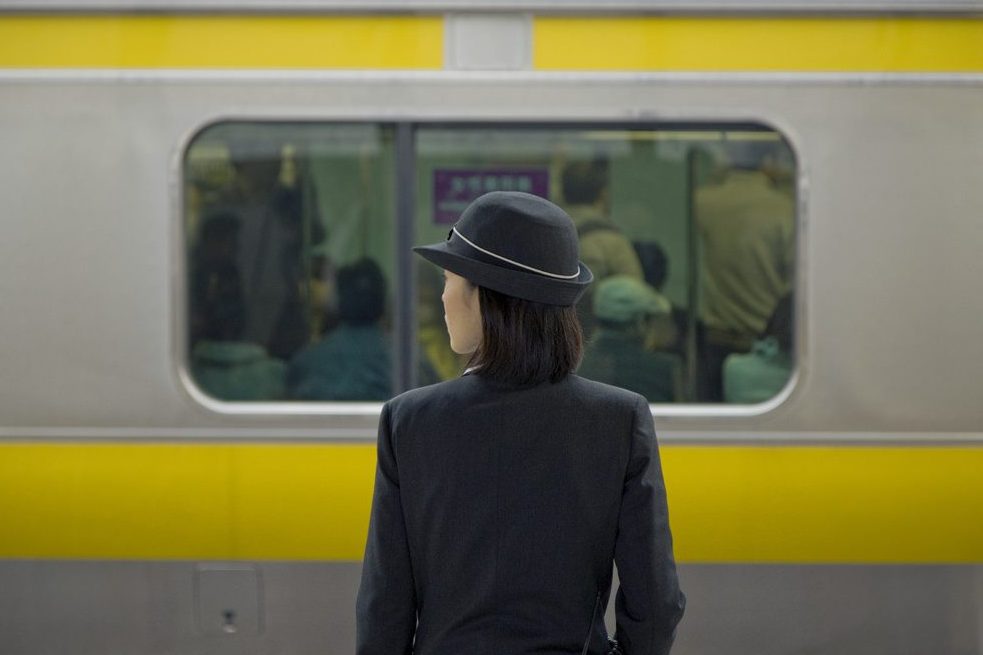 A woman is pictured on a train platform in Tokyo. Japanese business travelers tend to be unsatisfied with their experience.