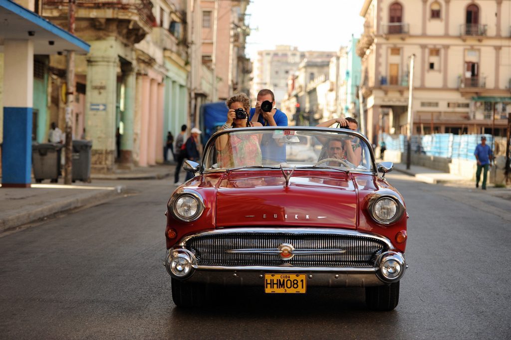 Cuban-American families will likely still be able to travel to Cuba, but everyone else may be barred under promised new Trump administration policies. U.S. tour operators aren't being deterred by policy changes towards Cuba. Pictured are tourists riding in a convertible in Havana. 
