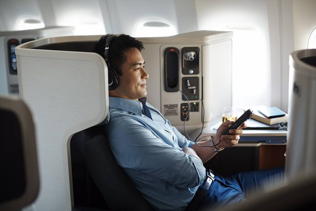 A business class passenger on a Cathay Pacific flight. Business travelers polled for this report indicated they are willing to book whatever they want regardless of their company's travel policy.