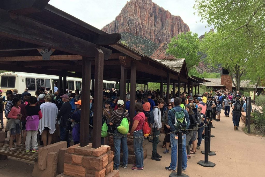 Tourists gather at Zion National Park in Utah. National Park Service advisory board members have quit out of frustration with the Interior Department's policies.