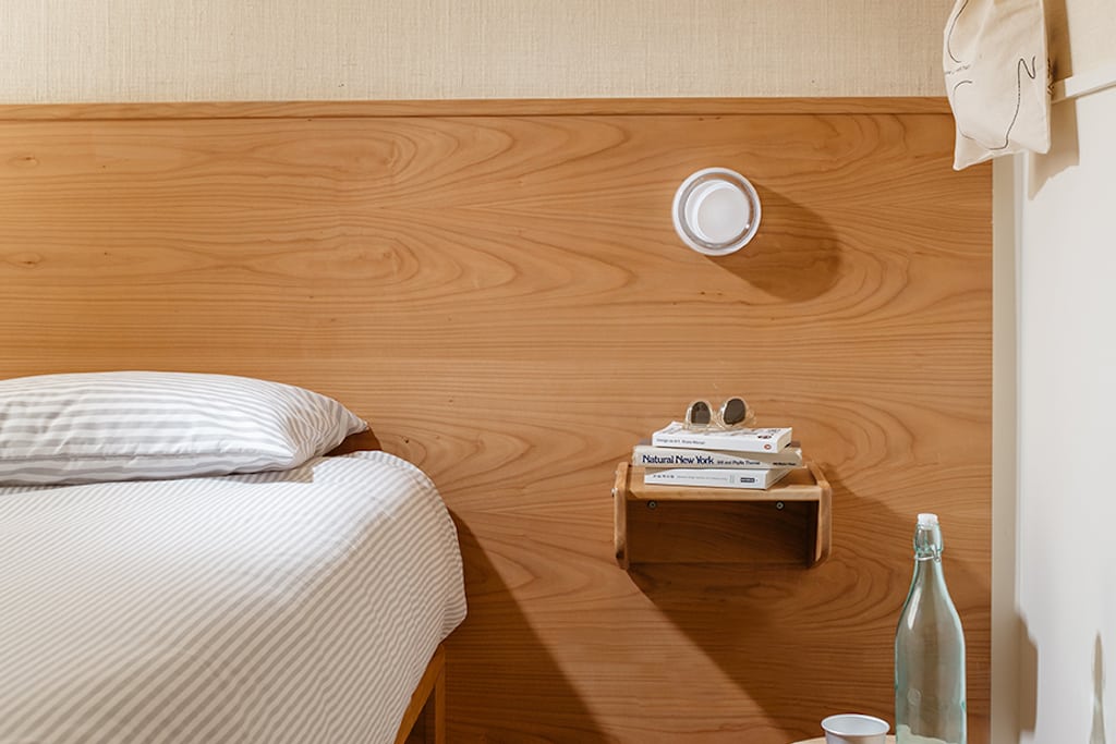 A promotional image of a guest room at Ace Hotel's newest property, Sister City.
