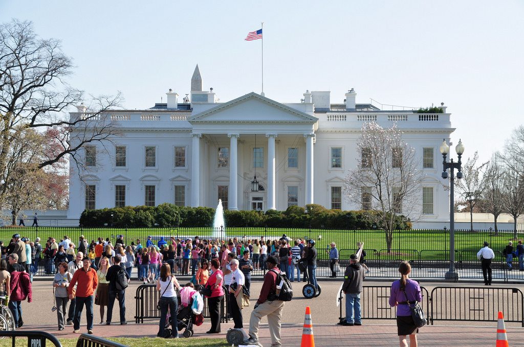 Pictured are tourists in front of the White House. The U.S. Travel Association is facing a prolonged dip in international tourist visits.