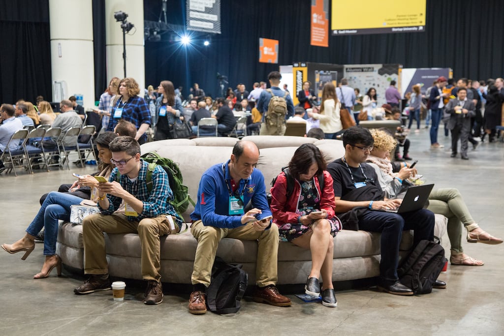 Attendees stare at their phones at the Collision Conference.