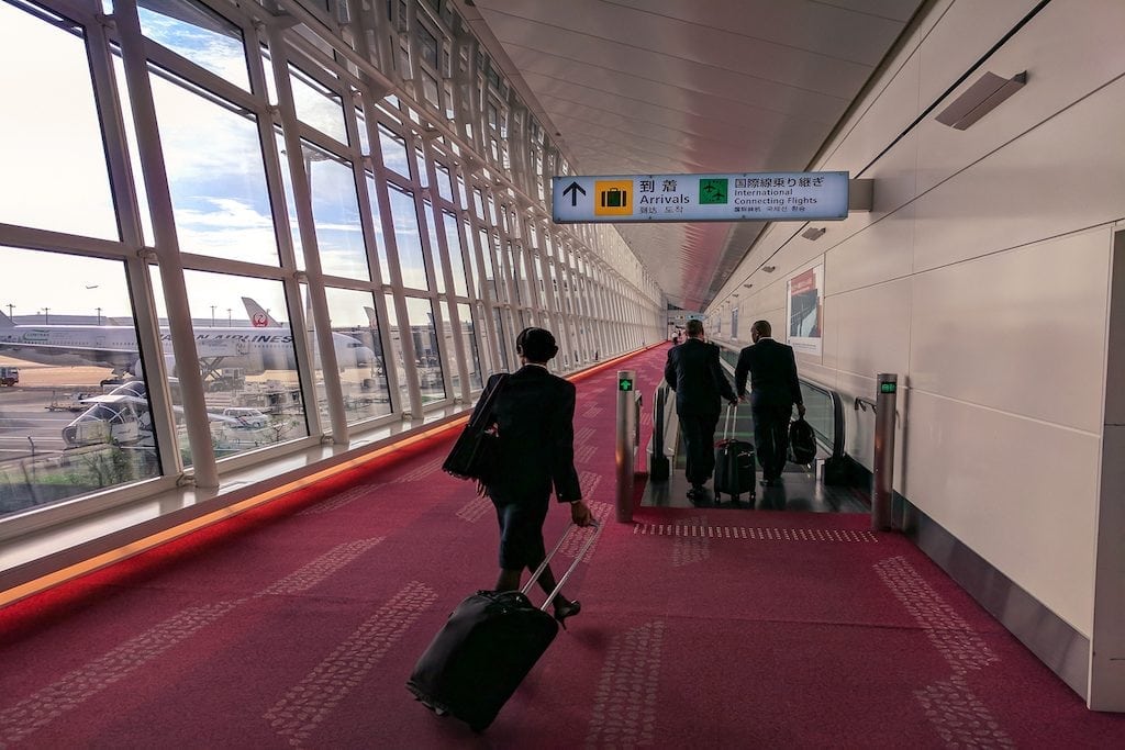Business travelers arrive at Haneda Airport in Tokyo. The foundational work is being done to help corporate travel catch up to online travel in terms of booking technology and service delivery.