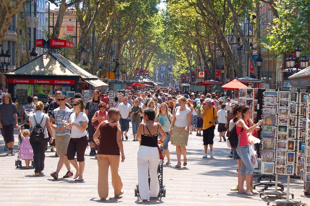 Tourists line the streets of Las Ramblas in Barcelona.