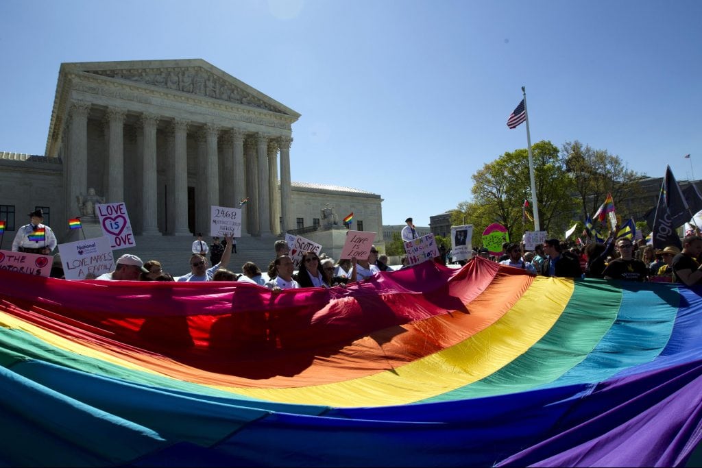 While marriage equality is now a reality in the U.S., many countries  criminalize same-sex relationships and some states do not have laws that prohibit discrimination. Experts say LGBTQ business travelers should prepare themselves with information when traveling to another country. Pictured are demonstrators outside the Supreme Court in 2015.