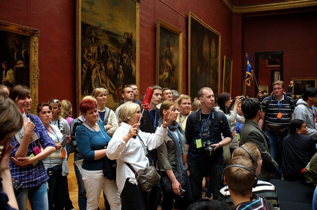 Tourism jobs continued to grow worldwide last year. Pictured is a tour group at the Louvre in Paris.