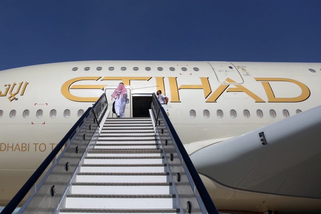 Staff at Etihad Airways will continue to work with reduced pay through September as the airline struggles with cash reserves. 