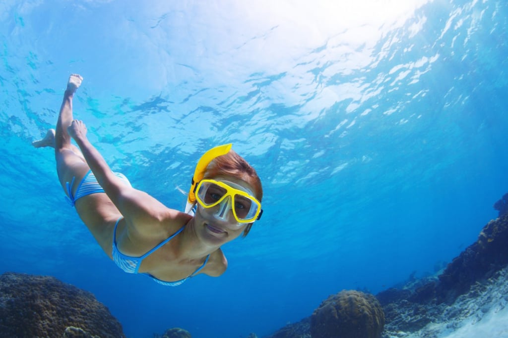 Expedia photo of a woman snorkeling. Some travel platforms have realized an increasing amount of money can be made from experience travel, including tours, activities, and restaurants. 