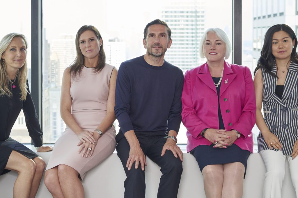 CEO Holger Bartel, center, poses for a photo with the other board members of his company, Travelzoo — the only U.S.-listed company to have 80 percent of its board of director seats held by women.