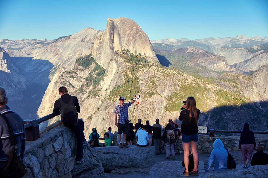 The Department of the Interior is reconsidering raising national park entrance fees. Pictured are travelers at Yosemite National Park in California.
