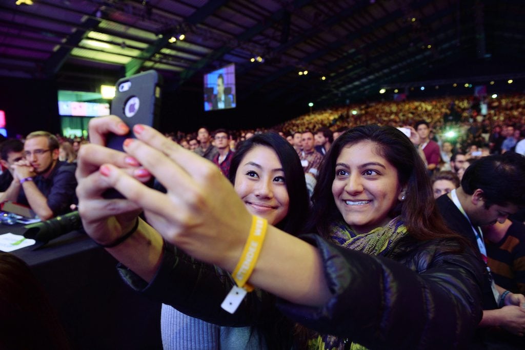 Two attendees take a selfie at the Web Summit. Planners are still figuring out how much technology is too much.