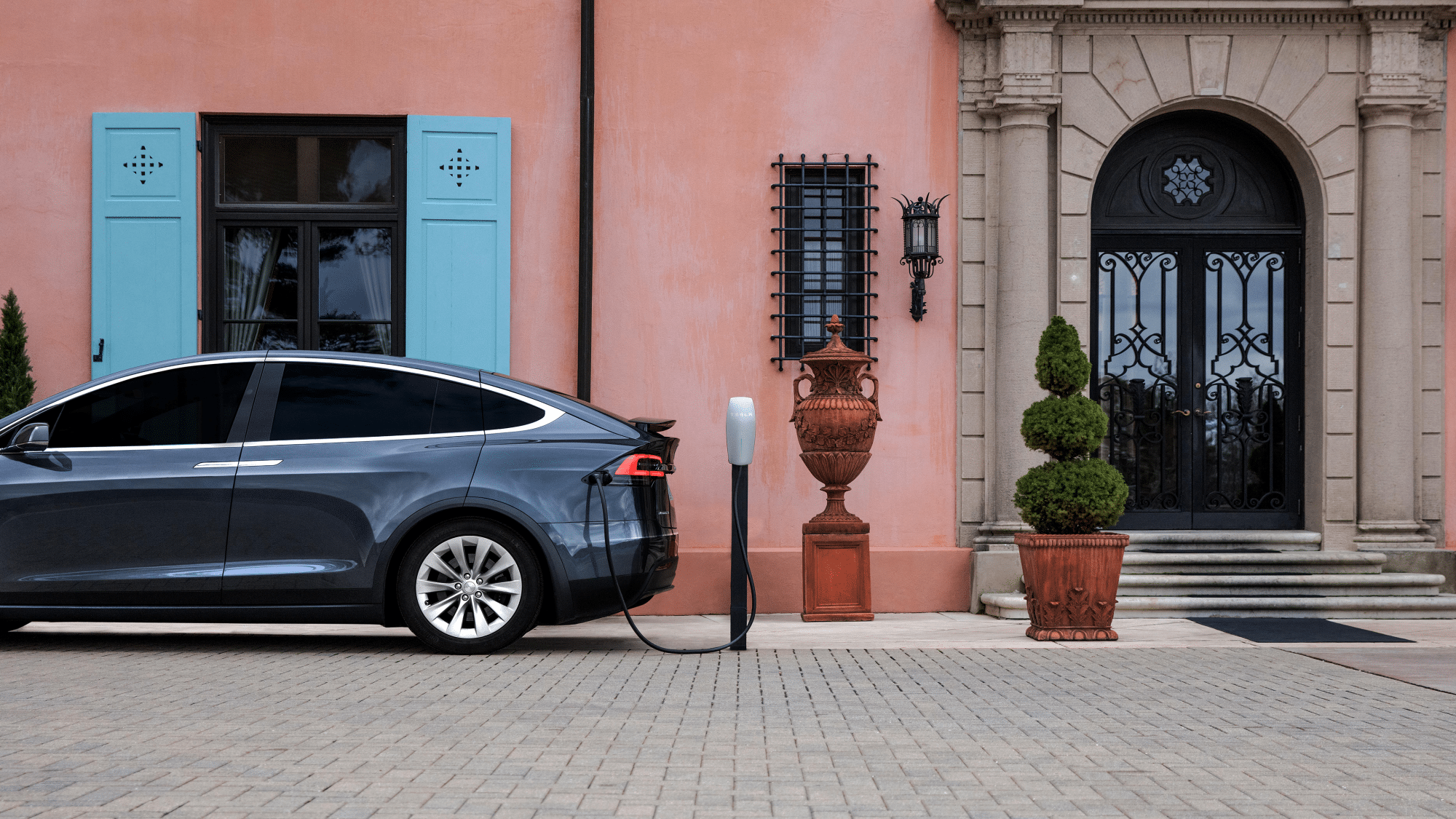 A Tesla at a hotel charging station. Electric vehicles are changing the anatomy of the road trip, but driverless cars will be even more impactful.