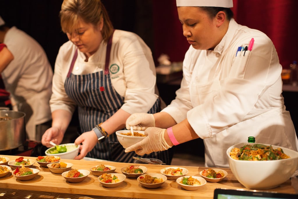 Chefs preparing dishes at a Culinary Institute of America event.