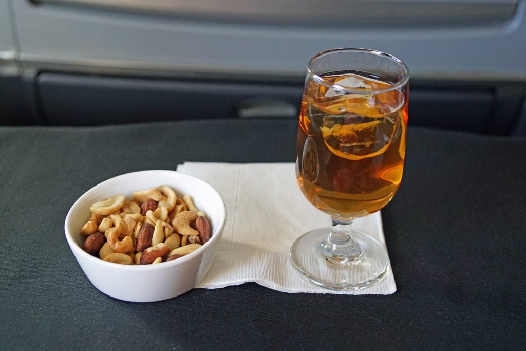 American Airlines' drink service for business class passengers with Japanese plum liqueur on October 22, 2014. Carriers must weigh the pros and cons of serving alcohol on board. 