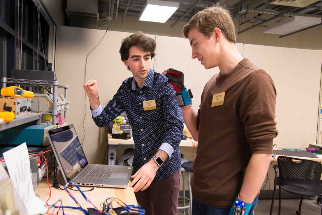 Two students at the University of Washington, Navid Azodi (left) and Thomas Pryor (right), demonstrate their invention of a glove that transliterates sign language into speech. Tools like that can help people with disabilities travel better. There's been a wave of efforts in the past year-and-a-half to help people with mobility, hearing, and sight challenges travel more easily.